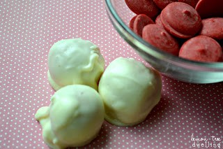 Oreo Truffles flavored with raspberry extract and decorated to look like adorable little Santa hats!