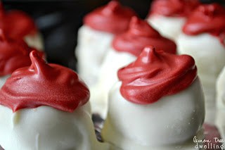 Oreo Truffles flavored with raspberry extract and decorated to look like adorable little Santa hats!