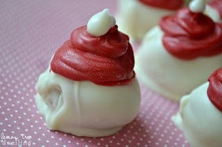 Oreo Truffles flavored with raspberry extract and decorated to look like adorable little Santa hats!