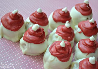 Oreo Truffles flavored with raspberry extract and decorated to look like adorable little Santa hats!