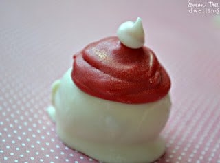 Oreo Truffles flavored with raspberry extract and decorated to look like adorable little Santa hats!