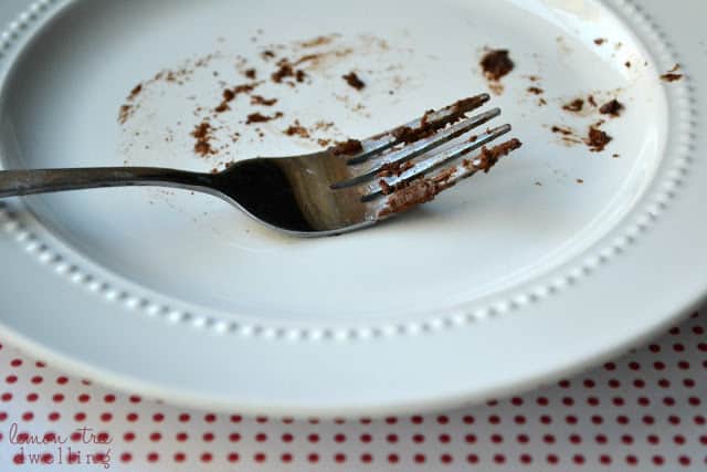 Fork on a plate with chocolate mocha cake crumbs on it