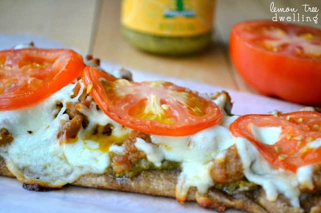 These Pesto Sausage Flatbreads combine traditional basil pesto with sweet Italian sausage to make an easy appetizer that is simply delicious! 