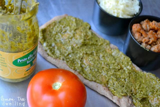 These Pesto Sausage Flatbreads combine traditional basil pesto with sweet Italian sausage to make an easy appetizer that is simply delicious! 