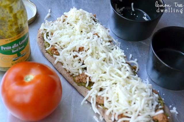 These Pesto Sausage Flatbreads combine traditional basil pesto with sweet Italian sausage to make an easy appetizer that is simply delicious! 