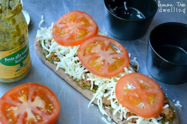 These Pesto Sausage Flatbreads combine traditional basil pesto with sweet Italian sausage to make an easy appetizer that is simply delicious! 