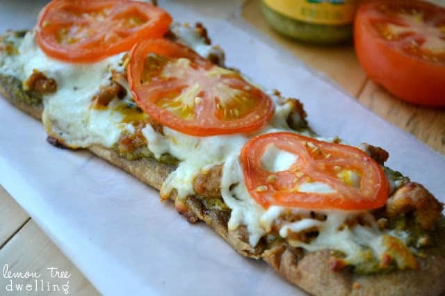 These Pesto Sausage Flatbreads combine traditional basil pesto with sweet Italian sausage to make an easy appetizer that is simply delicious! 