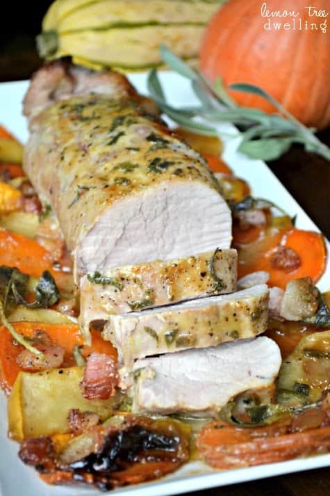 Maple Dijon Pork Tenderloin on a bed of sweet potatoes, apples, and bacon...all drizzled with a sweet and savory maple Dijon sauce and topped with fresh sage. This all in one meal is simply delicious!