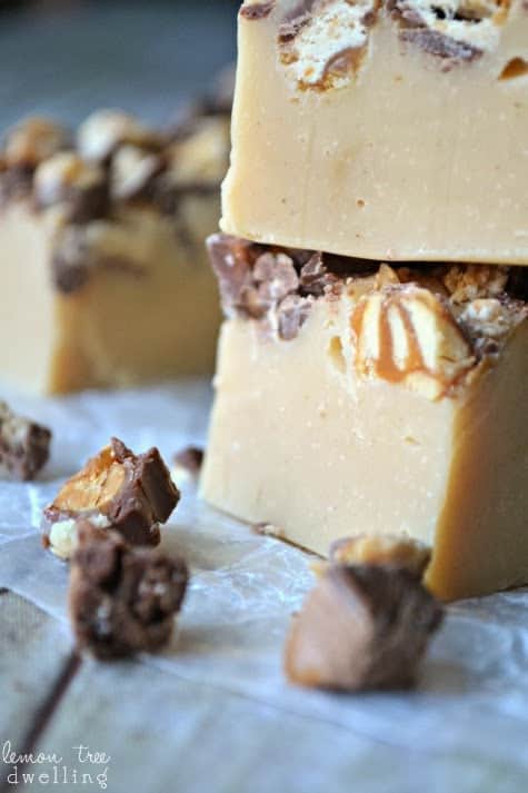 White Chocolate Peanut Butter Snickers Fudge will be the hit of your holiday party! These creamy fudge morsels take 5 minutes or less to make, and 2 seconds to eat! Simply delicious and a perfect sweet treat.