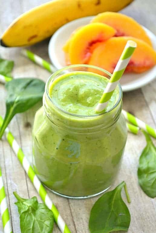 This Pineapple Peach Mango Green Smoothie is a delicious taste of the tropics! Loaded with peaches, mango, pineapple juice, bananas, and spinach....this smoothie is flavor-packed and perfect for any time of day! 