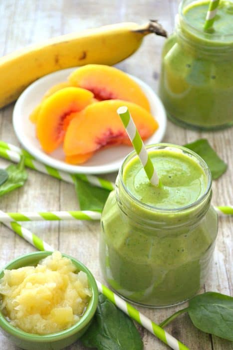 This Pineapple Peach Mango Green Smoothie is a delicious taste of the tropics! Loaded with peaches, mango, pineapple juice, bananas, and spinach....this smoothie is flavor-packed and perfect for any time of day! 