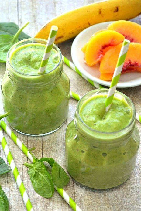 This Pineapple Peach Mango Green Smoothie is a delicious taste of the tropics! Loaded with peaches, mango, pineapple juice, bananas, and spinach....this smoothie is flavor-packed and perfect for any time of day! 