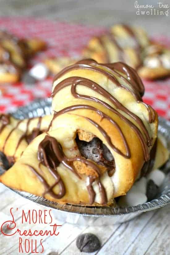  S'mores Crescent Rolls stuffed with chocolate chips, marshmallows, graham crackers and Nutella and topped with Nutella drizzle. Our favorite new way to enjoy s'mores!