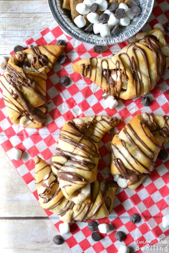  S'mores Crescent Rolls stuffed with chocolate chips, marshmallows, graham crackers and Nutella and topped with Nutella drizzle. Our favorite new way to enjoy s'mores!