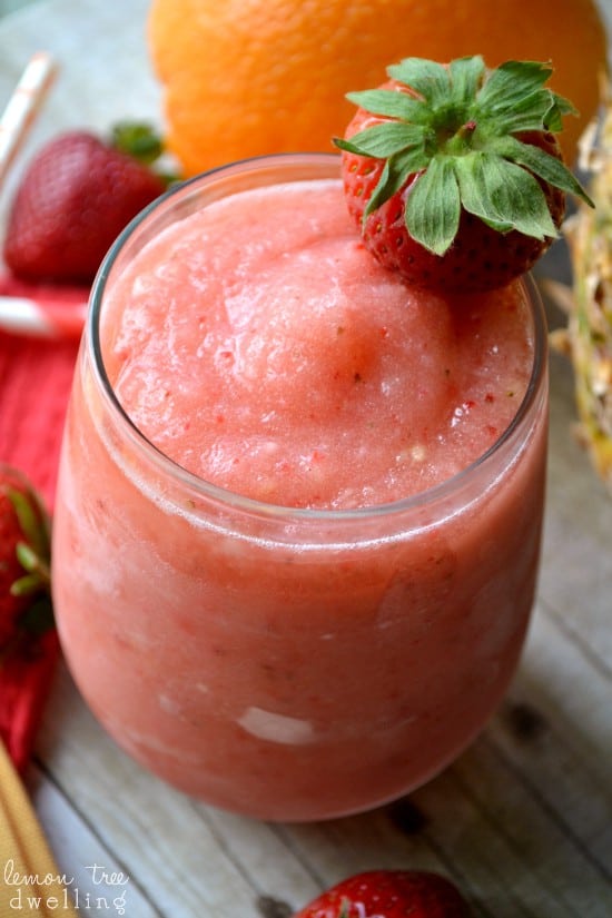 Tropical Frozen Sangria loaded with fresh strawberries, pineapple, and a hint of citrus. The perfect drink for summer!
