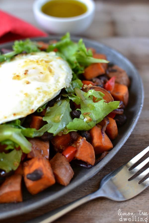  This Sweet Potato Breakfast Skillet is loaded with sweet potatoes, black beans, red bell pepper, purple onion, and a dash of hot sauce.....and topped with mixed greens, an over easy egg, and maple mustard vinaigrette. SO much flavor in one skillet!!
