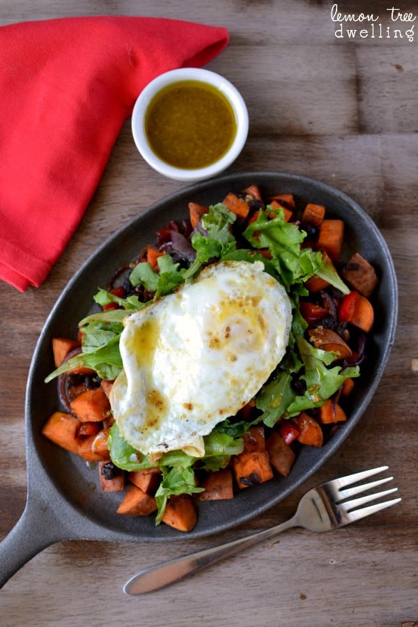  This Sweet Potato Breakfast Skillet is loaded with sweet potatoes, black beans, red bell pepper, purple onion, and a dash of hot sauce.....and topped with mixed greens, an over easy egg, and maple mustard vinaigrette. SO much flavor in one skillet!!