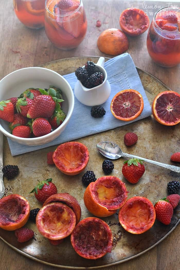  Delicious Blood Orange Sangria made with white wine, rum, and triple sec and garnished with fresh berries. 