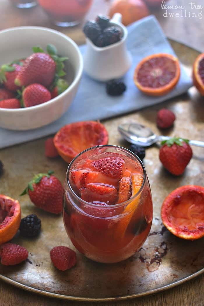  Delicious Blood Orange Sangria made with white wine, rum, and triple sec and garnished with fresh berries. 