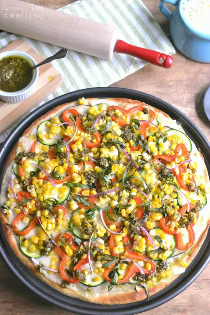 Homemade Garden Vegetable Pesto Pizza starts with a delicious garlic cream sauce topped with mozzarella cheese, eggplant, zucchini, red peppers, sweet corn, fresh basil, and a drizzle of pesto . The perfect summer pizza, straight from the garden! #mypicknsave #sp