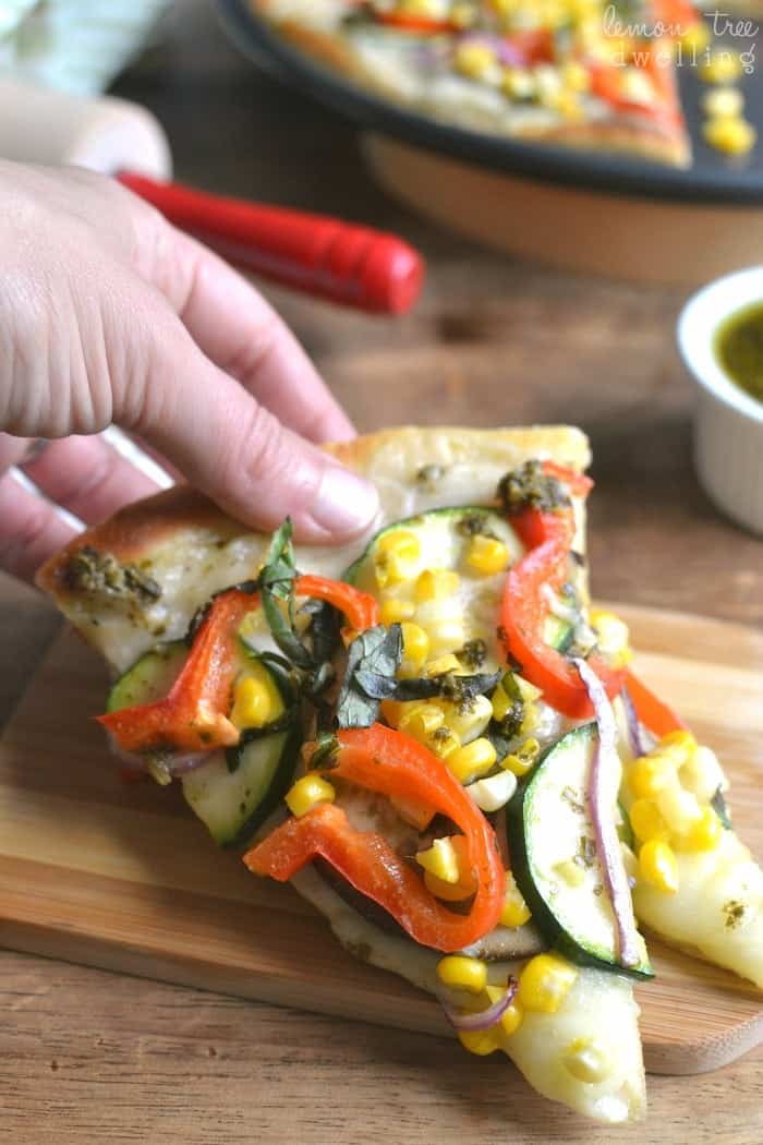 Homemade Garden Vegetable Pesto Pizza starts with a delicious garlic cream sauce topped with mozzarella cheese, eggplant, zucchini, red peppers, sweet corn, fresh basil, and a drizzle of pesto . The perfect summer pizza, straight from the garden! #mypicknsave #sp