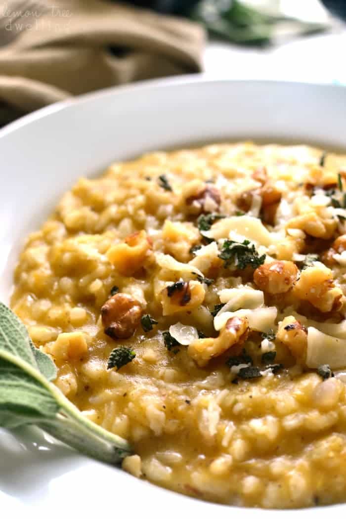 This Butternut Squash Risotto is rich and creamy, flavored with allspice, walnuts, parmesan, and chardonnay. It's the perfect fall risotto, and a delicious addition to any holiday table!