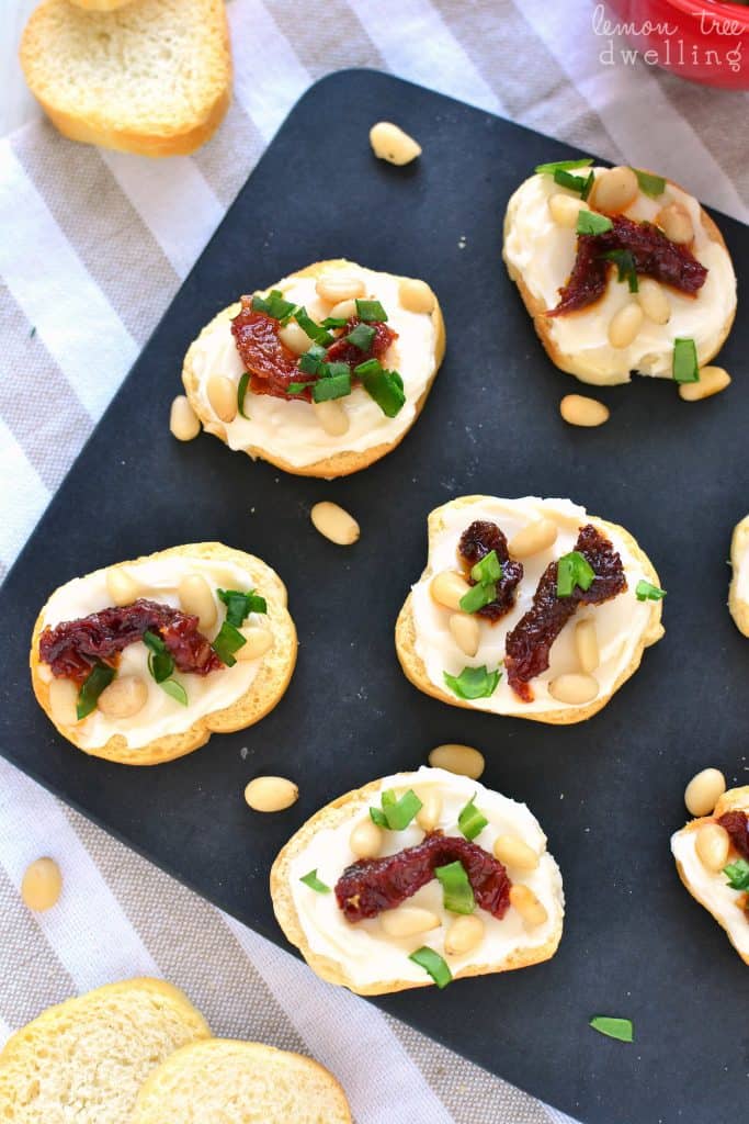 Sun Dried Tomato Asiago Crostini is made with just 5 simple ingredients and packed with delicious flavor! Perfect for snacking, sharing, or serving at your next party!