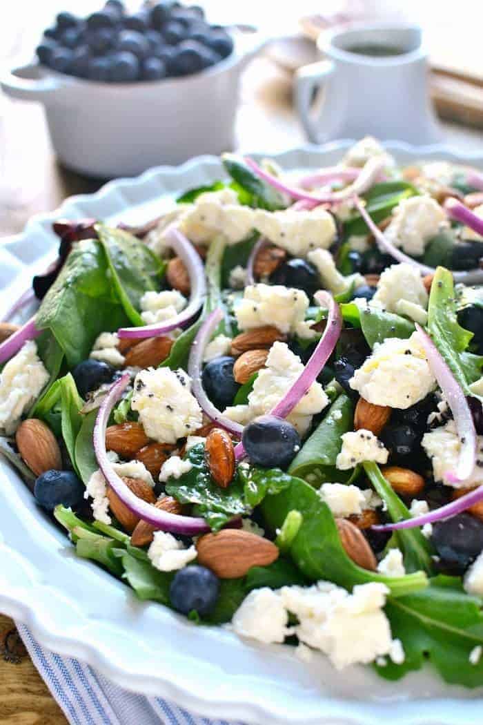 This Blueberry Feta Salad is your new go-to salad for spring! It combines fresh blueberries with feta cheese, almonds, and a lemon poppyseed vinaigrette. Perfect for a baby shower or Easter celebration!