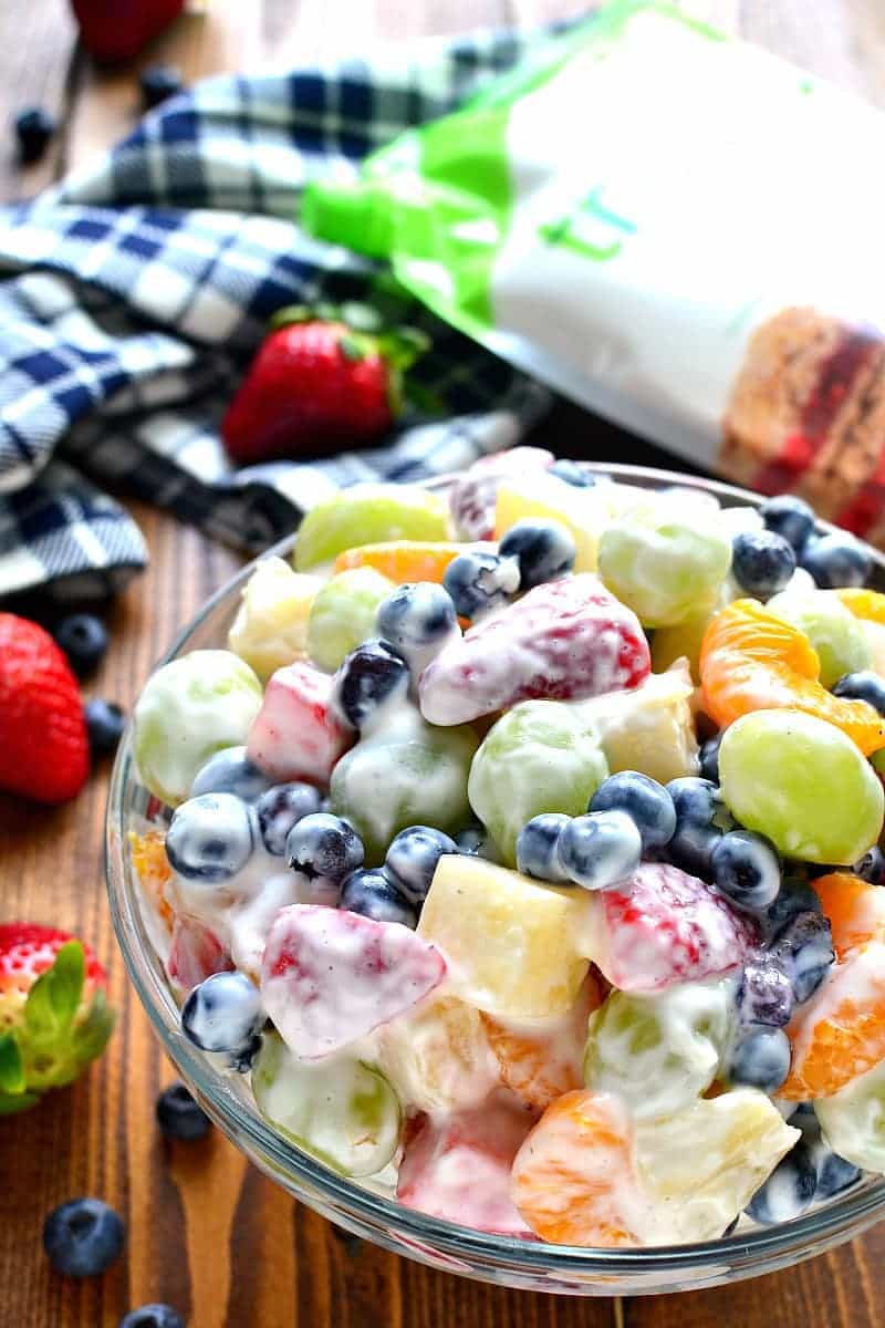 This Skinny Ambrosia Fruit Salad combines 5 types of fruit with a sweetened Greek yogurt sauce - the perfect {healthier} way to dress up your ordinary fruit salad!