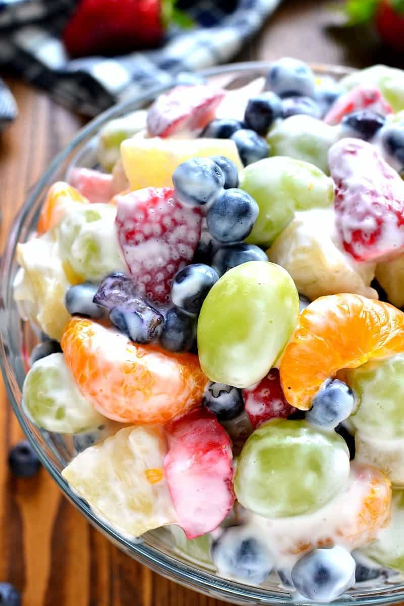 This Skinny Ambrosia Fruit Salad combines 5 types of fruit with a sweetened Greek yogurt sauce - the perfect {healthier} way to dress up your ordinary fruit salad!