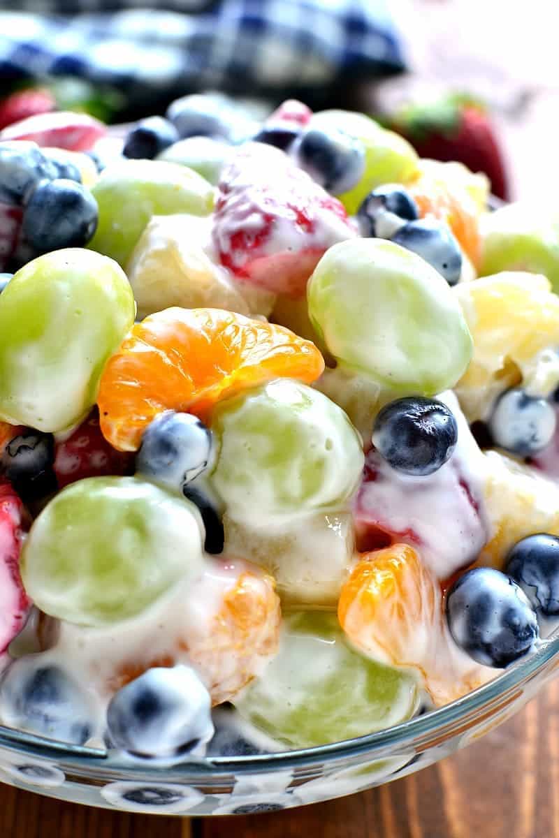 This Skinny Ambrosia Fruit Salad combines 5 types of fruit with a sweetened Greek yogurt sauce - the perfect {healthier} way to dress up your ordinary fruit salad!