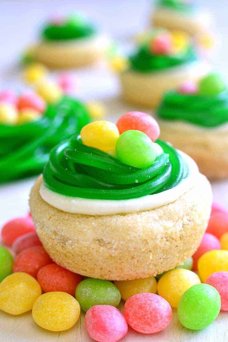 These Easter Egg Cookie Cups are easy, adorable, and so delicious! These quick and easy sugar cookies are topped with lemon buttercream, and Easter candy.