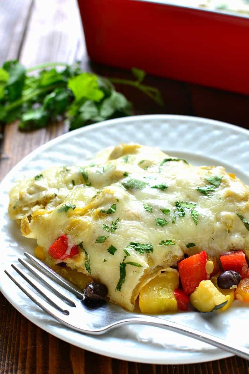 These Roasted Vegetable Enchiladas are packed with fresh veggies, corn, and black beans, then topped with a creamy chile verde sauce and melted Monterey Jack cheese. The perfect option for a healthy, flavor packed, meatless dinner!