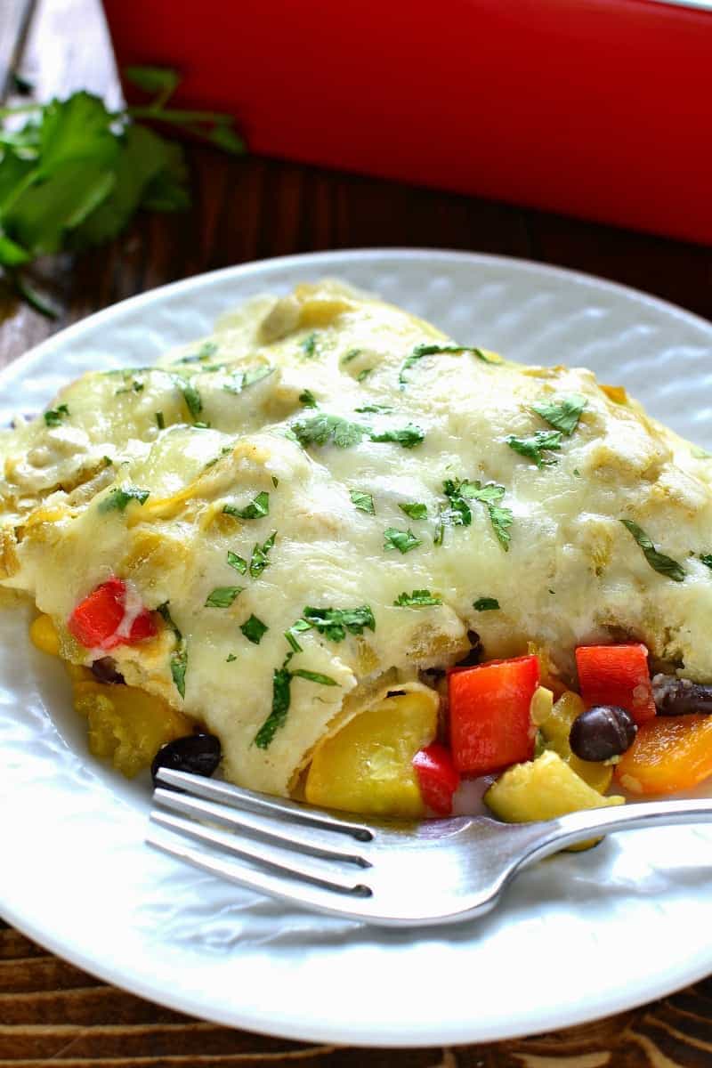 These Roasted Vegetable Enchiladas are packed with fresh veggies, corn, and black beans, then topped with a creamy chile verde sauce and melted Monterey Jack cheese. The perfect option for a healthy, flavor packed, meatless dinner!