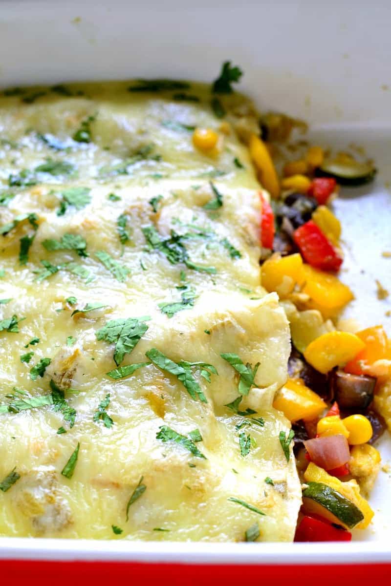 These Roasted Vegetable Enchiladas are packed with fresh veggies, corn, and black beans, then topped with a creamy chile verde sauce and melted Monterey Jack cheese. The perfect option for a healthy, flavor packed, meatless dinner!