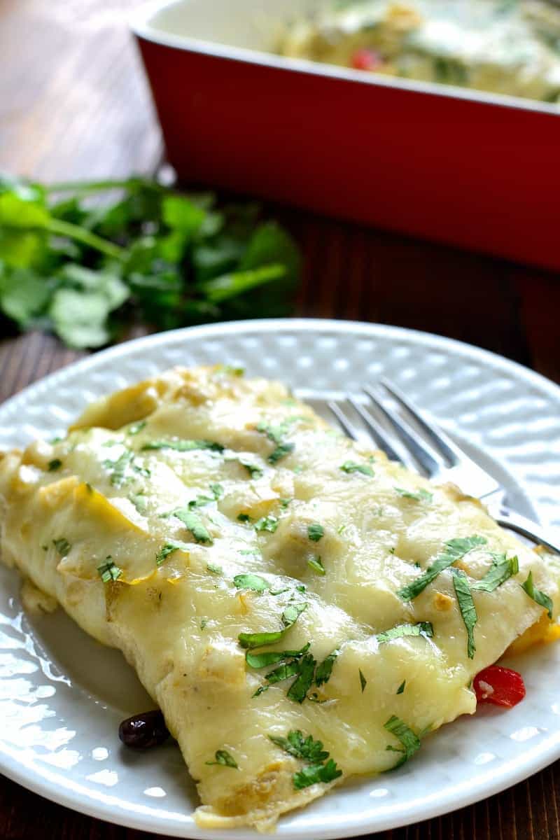 These Roasted Vegetable Enchiladas are packed with fresh veggies, corn, and black beans, then topped with a creamy chile verde sauce and melted Monterey Jack cheese. The perfect option for a healthy, flavor packed, meatless dinner!