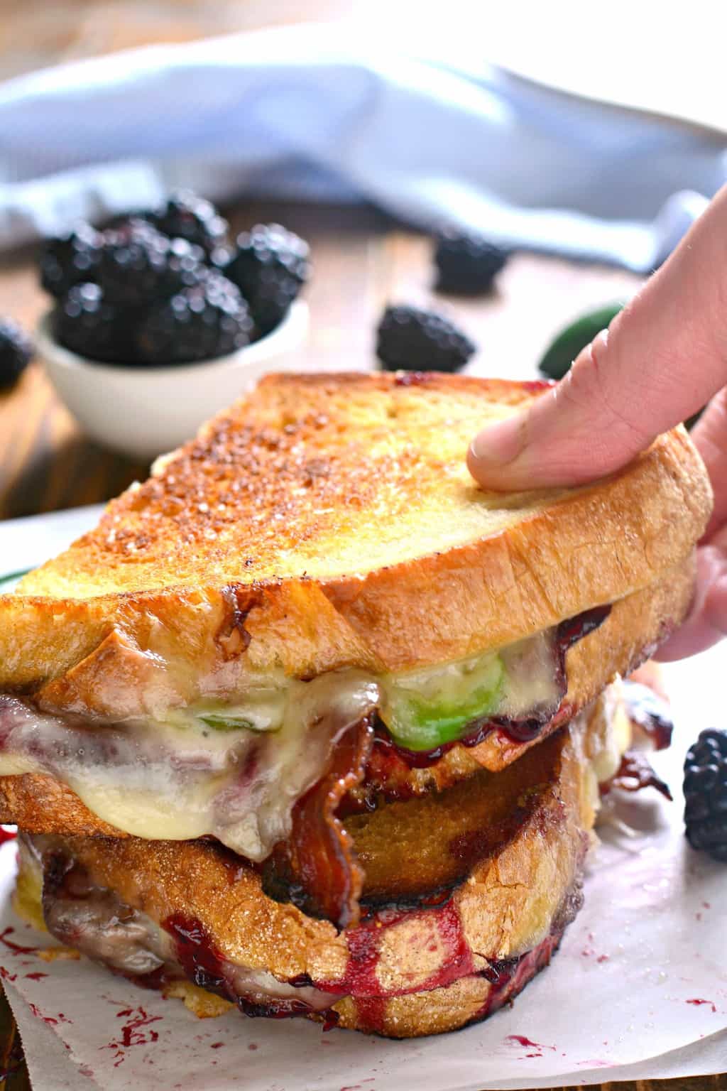 hand holding a Blackberry Bacon Grilled Cheese