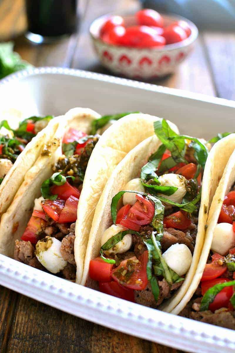 Soft Tacos filled with ground beef and the ingredients of a caprese salad