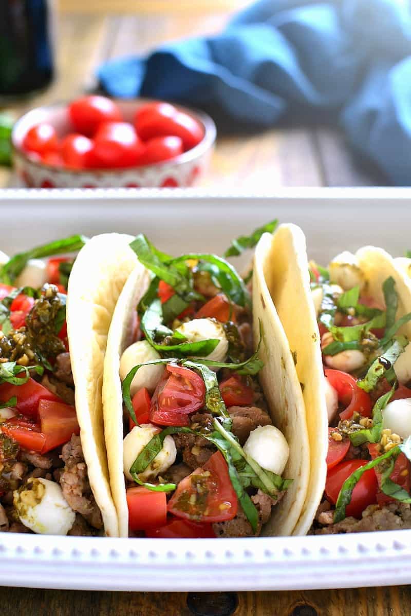 soft flour tortilla tacos filled with the ingredients of a caprese salad