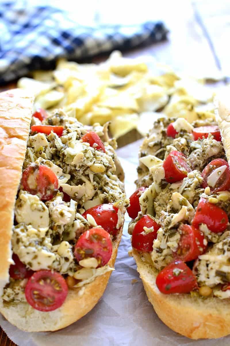 2 Pesto Chicken Salad sandwiches on sub rolls sitting side by side