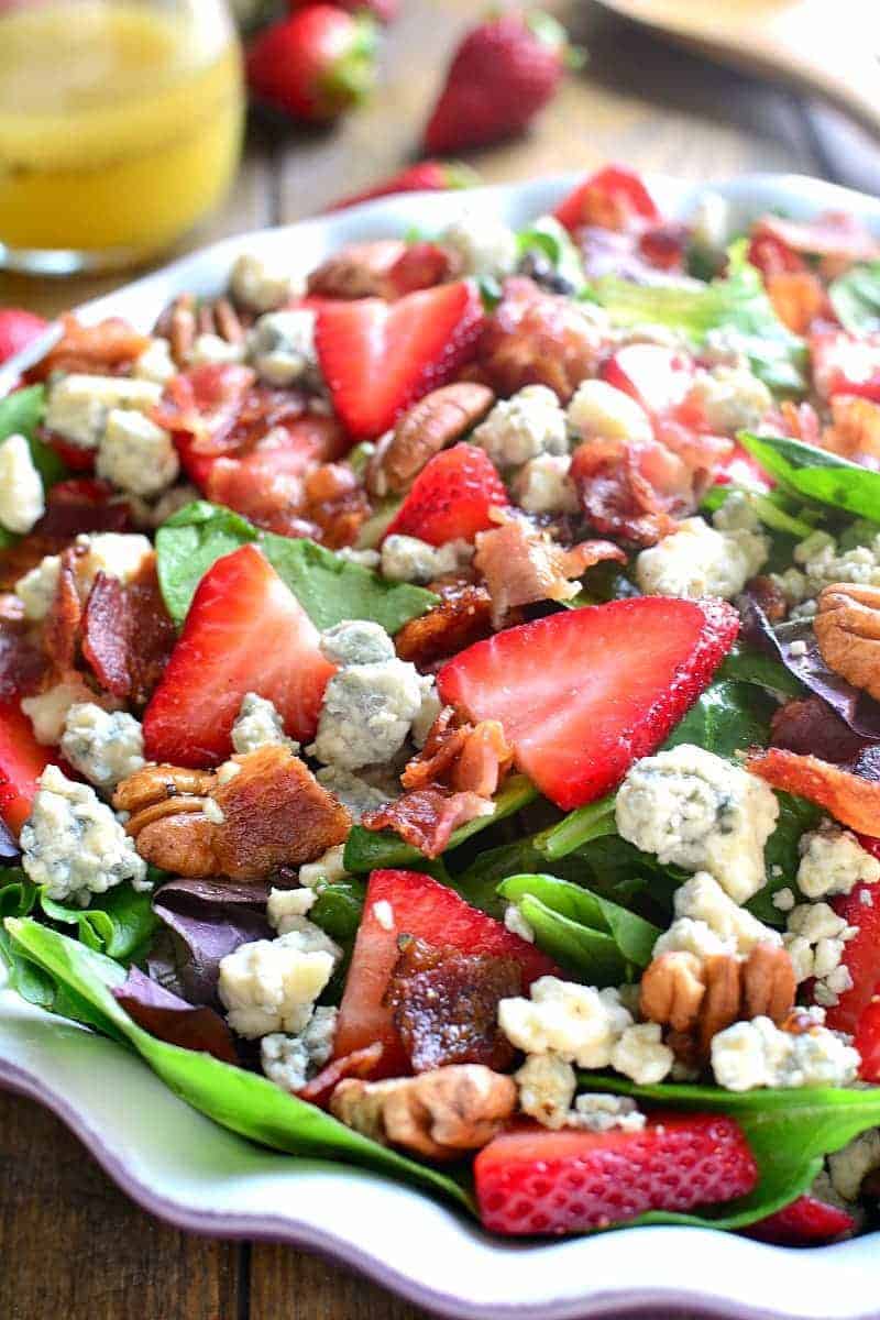 a scalloped bowl filled with Strawberry Bacon Blue Cheese Salad