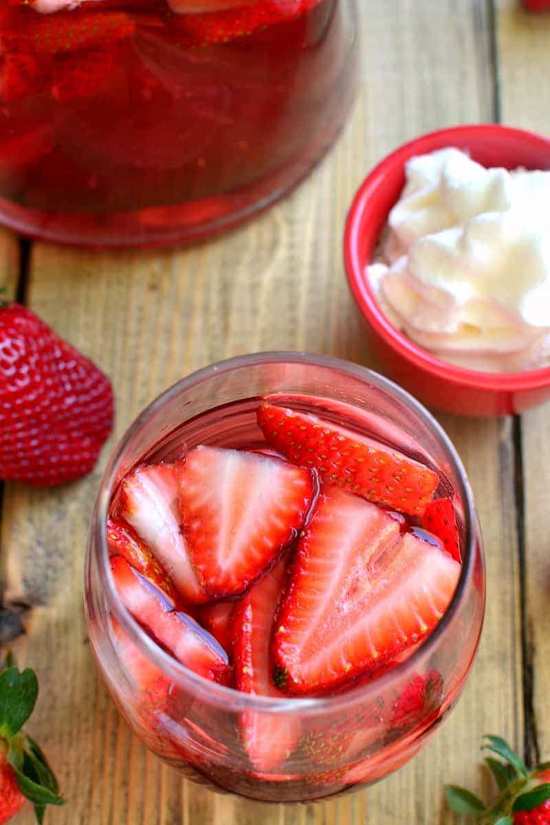 overhead photo of a white wine sangria with sliced strawberries floating in it