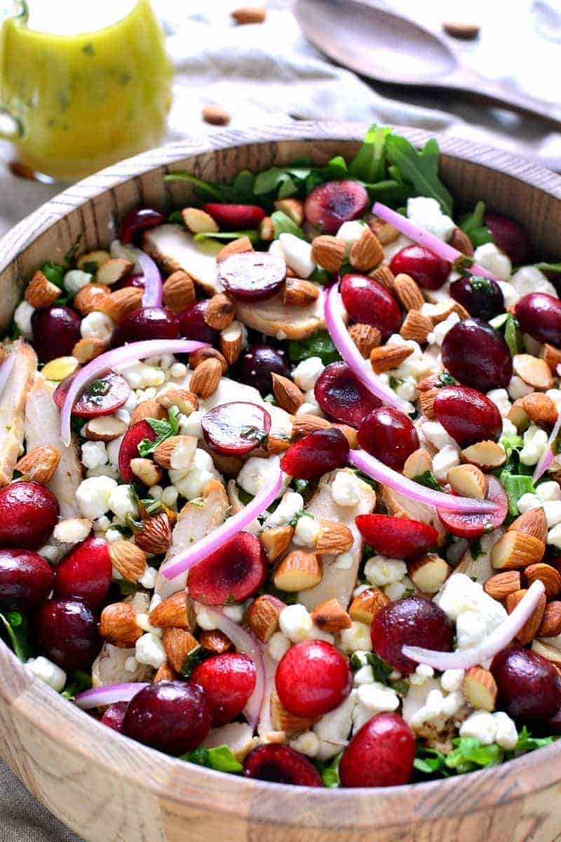 This Cherry Almond Arugula Salad combines fresh baby arugula with sweet cherries, almonds, goat cheese, and grilled chicken for delicious summer salad that's perfect as a main dish or on the side!