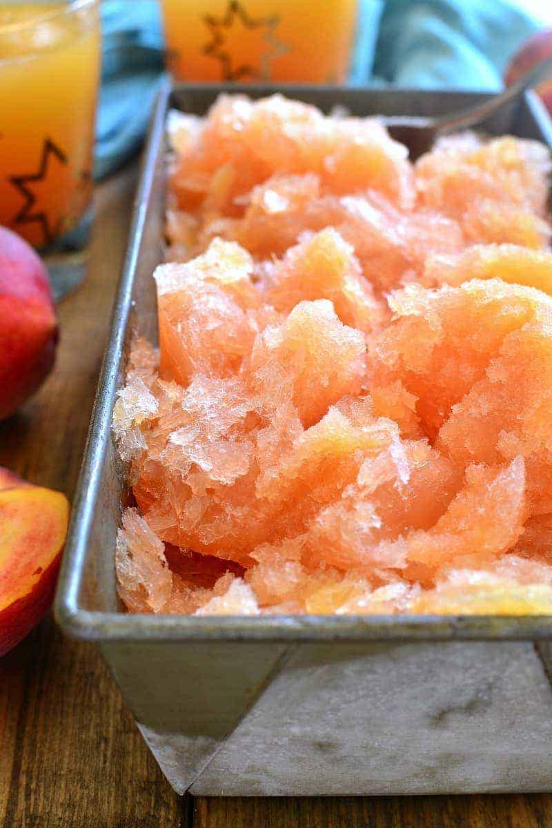 This Frozen Peach Slush is a delicious blend of citrus, peach tea, peach schnapps, and brandy...topped off with your favorite sparkling soda! Perfect for parties, special occasions, or lazy summer days. The perfect drink for summer!