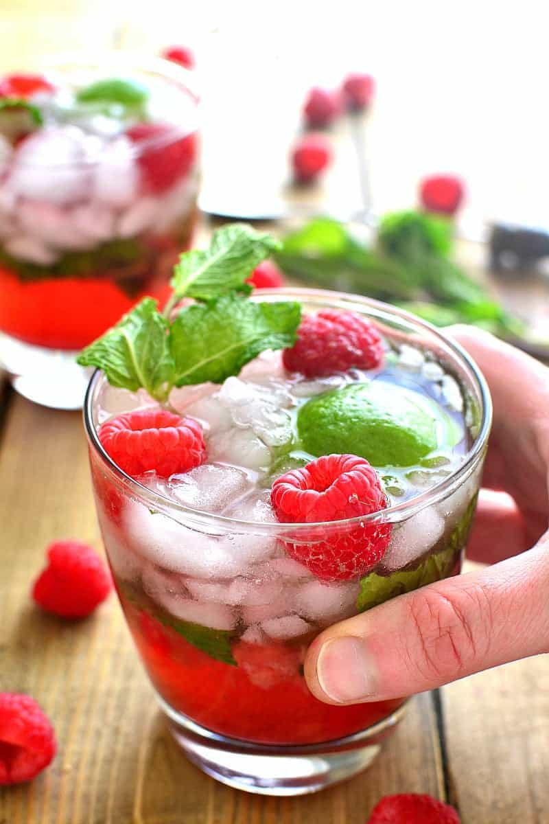 Skinny Raspberry Mojitos combine classic mojito flavors with fresh raspberries in a skinny cocktail that's perfect for summer!