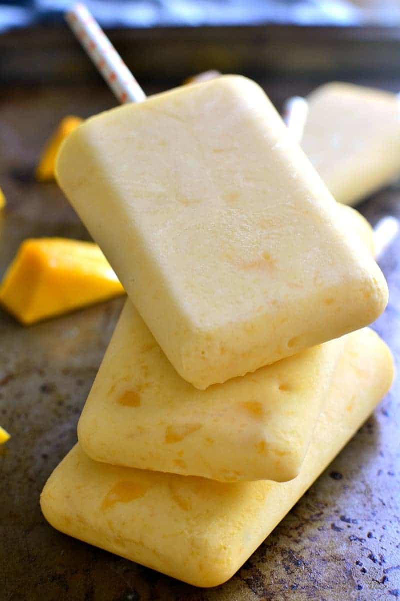 These Mango Cream Popsicles are fruity, creamy, and so delicious! They come together in minutes and are the perfect way to cool off on a hot summer day!