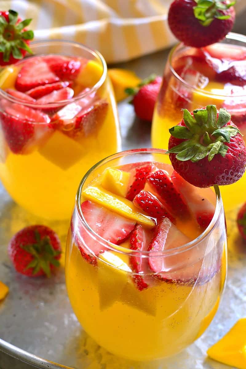 This Strawberry Mango Sangria combines so many summer favorites in one delicious drink! Perfect for parties, ladies' nights, or lazy summer weekends, this sangria is destined to become your new go-to drink!