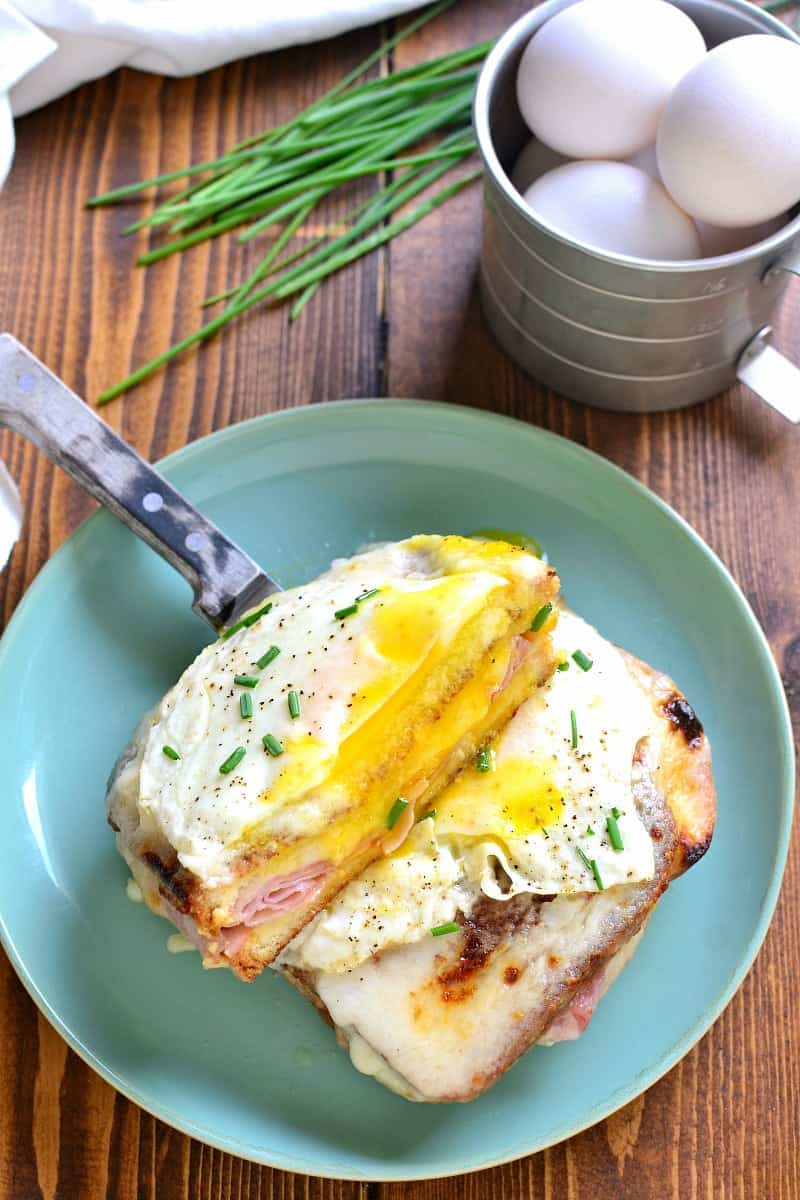 A Classic Croque Madame - made with sliced ham, swiss cheese, creamy béarnaise sauce, and a fried egg on top. Go ahead....indulge! It's worth it!