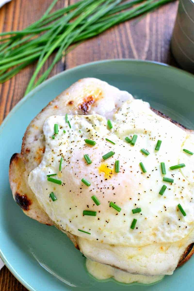 A Classic Croque Madame - made with sliced ham, swiss cheese, creamy béarnaise sauce, and a fried egg on top. Go ahead....indulge! It's worth it!