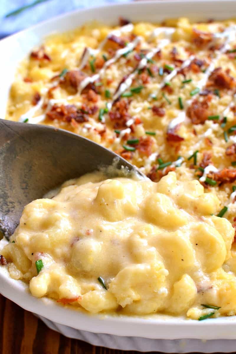 Deliciously creamy Baked Mac & Cheese, loaded with sour cream, bacon, and chives and topped with buttery bread crumbs. The BEST mac & cheese ever....sure to become a family favorite!